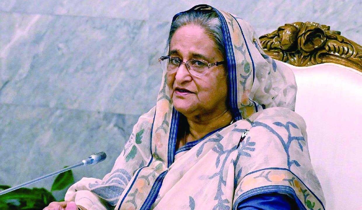 Sheikh Hasina seated, speaking
